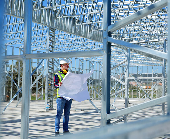 construction worker in middle of steel structure